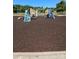 View of a colorful playground with climbing structures, spring riders, and soft rubber ground, great for  at 110 Canary Ln # 3, Mooresville, NC 28115