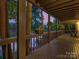 Cozy porch with wood floors and sunset lake views, perfect for relaxing outdoors at 1114 Palmyra Dr, Tega Cay, SC 29708