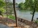 Backyard with fire pit near the lake and steps leading down to the water at 1114 Palmyra Dr, Tega Cay, SC 29708