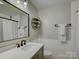 Bathroom with new vanity, modern fixtures, and decorative mirror with shelves at 1114 Palmyra Dr, Tega Cay, SC 29708