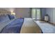 Light-filled primary bedroom featuring a plush bed, hardwood floors, and french doors to the porch at 1114 Palmyra Dr, Tega Cay, SC 29708