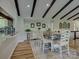 Well-lit dining room with hardwood floors, exposed beams, and seating for six at the dining table at 1114 Palmyra Dr, Tega Cay, SC 29708