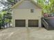 Attached two-car garage offers parking and storage solutions and access to the lake at 1114 Palmyra Dr, Tega Cay, SC 29708