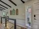 Hallway with dark wood beams and art decoration in neutral color interior at 1114 Palmyra Dr, Tega Cay, SC 29708