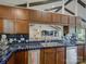 Bright kitchen with stainless steel appliances and dark blue tiled countertops and backsplash at 1114 Palmyra Dr, Tega Cay, SC 29708