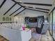 An open living room with a cozy seating area, wood floors, built-in shelving and a modern entertainment center at 1114 Palmyra Dr, Tega Cay, SC 29708