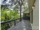 Spacious back porch with views of the lake and lots of shade from the surrounding forest at 1114 Palmyra Dr, Tega Cay, SC 29708