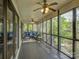 A spacious screened porch with comfortable seating and a view of the lush, green outdoors at 1114 Palmyra Dr, Tega Cay, SC 29708