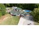 Expansive aerial view of property with a pool, detached garage, green lawn, and carport at 1115 Old Thompson Ave, Lancaster, SC 29720