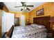 A cozy bedroom featuring a patterned quilt and wood paneling at 1115 Old Thompson Ave, Lancaster, SC 29720