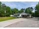 Well-kept home with a green roof, covered parking, manicured lawn, and a beautiful landscape at 1115 Old Thompson Ave, Lancaster, SC 29720