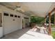 Covered patio with a two-car garage, ceiling fans, and comfortable seating for outdoor enjoyment at 1115 Old Thompson Ave, Lancaster, SC 29720