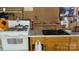 Functional kitchen space with a white gas range and wooden cabinets at 1115 Old Thompson Ave, Lancaster, SC 29720