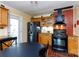 Charming kitchen with stainless steel appliances, wooden cabinetry, and brick accent wall at 1115 Old Thompson Ave, Lancaster, SC 29720