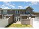 The back of this home features neutral colored siding, an open backyard, and a patio at 11229 Lions Mane St, Charlotte, NC 28273