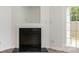 Close-up of the fireplace in the living room with a white mantel and black hearth at 11229 Lions Mane St, Charlotte, NC 28273
