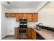 Functional kitchen with stainless steel appliances, wooden cabinets and tile flooring at 11229 Lions Mane St, Charlotte, NC 28273