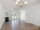 Spacious living room with hardwood floors, a fireplace, and a chandelier at 11229 Lions Mane St, Charlotte, NC 28273