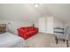 Bright bedroom featuring a sloped ceiling, natural light, bed, red sofa, and keyboard at 1125 Silvertrace Dr, Salisbury, NC 28144