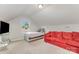 Bright bedroom featuring a sloped ceiling, natural light, bed, and red sofa at 1125 Silvertrace Dr, Salisbury, NC 28144