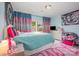 Colorful bedroom boasts blue walls, vibrant curtains, and cozy decor for a playful and inviting space at 1125 Silvertrace Dr, Salisbury, NC 28144