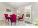 Cozy dining area features wood-look floors, bright windows, and stylish red chairs surrounding a round table at 1125 Silvertrace Dr, Salisbury, NC 28144