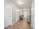 Inviting hallway with wood-look floors, neutral paint, and white doors creates a welcoming entrance at 1125 Silvertrace Dr, Salisbury, NC 28144