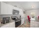 Well-lit kitchen features stainless steel appliances, granite countertops, and white cabinetry for a modern feel at 1125 Silvertrace Dr, Salisbury, NC 28144