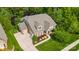Aerial view of home with three-car garage, lush landscaping, and well-maintained lawn at 11424 Brangus Ln, Mint Hill, NC 28227