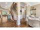 Spacious foyer showcasing hardwood floors, staircase, and elegant architectural details at 11424 Brangus Ln, Mint Hill, NC 28227