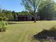 Welcoming single-Gathering home with a neat lawn and mature trees, set back from the street at 12016 Brief Rd, Charlotte, NC 28227