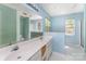 Bathroom featuring a double sink vanity with a large mirror and tile accents at 12016 Gemstone Ct, Charlotte, NC 28269