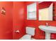 Bathroom featuring a sink, toilet and bright, red walls at 12016 Gemstone Ct, Charlotte, NC 28269