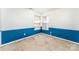 Empty bedroom featuring chair railing, two windows, and carpeted floors at 12016 Gemstone Ct, Charlotte, NC 28269