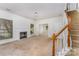 Bright living room with a fireplace and staircase showcasing the home's potential for cozy Gathering living at 12016 Gemstone Ct, Charlotte, NC 28269