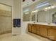 Bright bathroom featuring a dual sink vanity, large mirror, and glass-enclosed shower at 1222 Kings Bottom Dr, Fort Mill, SC 29715