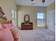Bedroom features neutral paint, a wooden dresser, two windows providing ample natural light at 1222 Kings Bottom Dr, Fort Mill, SC 29715