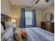 Comfortable bedroom features neutral walls, a window with blue curtains and striped bedding at 1222 Kings Bottom Dr, Fort Mill, SC 29715