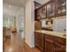 Butler's pantry with granite counters, dark wood cabinetry, and views to the kitchen and living room at 1222 Kings Bottom Dr, Fort Mill, SC 29715