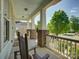 Inviting covered porch with rocking chairs, brick supports, and a view of the street and blooming flowers at 1222 Kings Bottom Dr, Fort Mill, SC 29715