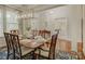 Well-lit dining room featuring hardwood floors, a large table set for dinner, and an elegant chandelier at 1222 Kings Bottom Dr, Fort Mill, SC 29715