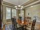 Elegant dining room features a coffered ceiling, large windows, and a stylish chandelier at 1222 Kings Bottom Dr, Fort Mill, SC 29715