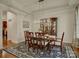 Formal dining room with a dark wood table, upholstered chairs, a modern chandelier, and elegant decor at 1222 Kings Bottom Dr, Fort Mill, SC 29715
