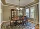 Formal dining room with elegant chandelier and beautiful hardwood floors at 1222 Kings Bottom Dr, Fort Mill, SC 29715