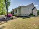 Side view of home with a screened-in porch and manicured landscaping at 1222 Kings Bottom Dr, Fort Mill, SC 29715