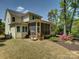 Back of home featuring a screened-in patio with lush landscaping at 1222 Kings Bottom Dr, Fort Mill, SC 29715