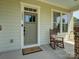 Charming front door with covered porch and seating at 1222 Kings Bottom Dr, Fort Mill, SC 29715