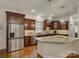 Updated kitchen with dark wood cabinets, stainless steel appliances, granite countertops, and hardwood floors at 1222 Kings Bottom Dr, Fort Mill, SC 29715