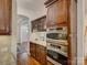 This kitchen is equipped with stainless steel, double ovens and dark wood cabinets at 1222 Kings Bottom Dr, Fort Mill, SC 29715