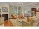 Open-concept living room with fireplace, hardwood floors, and access to the kitchen and dining area at 1222 Kings Bottom Dr, Fort Mill, SC 29715